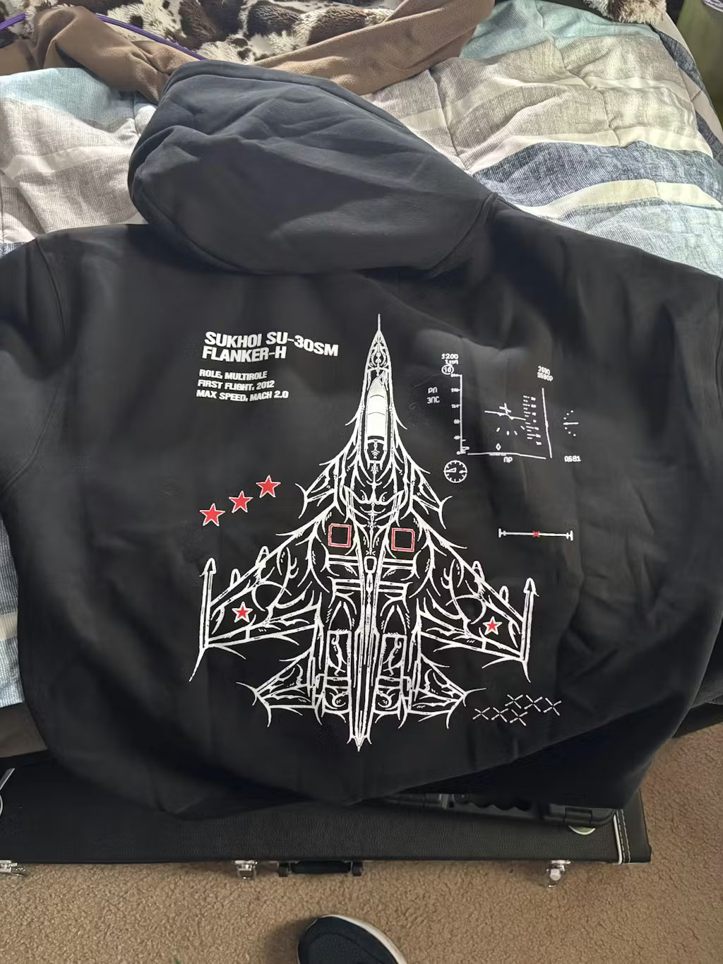 Black hoodie with Sukhoi SU-30SM jet blueprint and aviation graphics on back