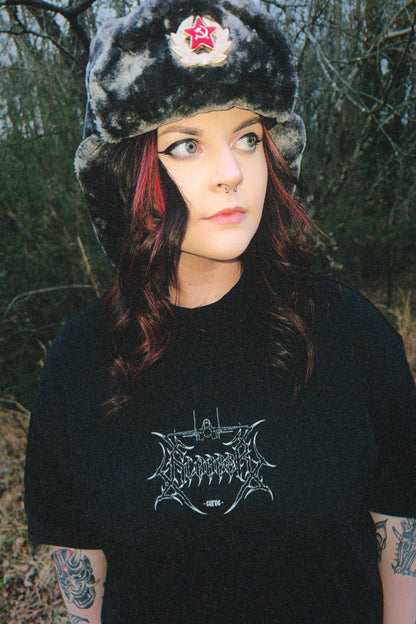 Woman outdoors wearing aviation-inspired graphic tee and faux fur hat with red star badge