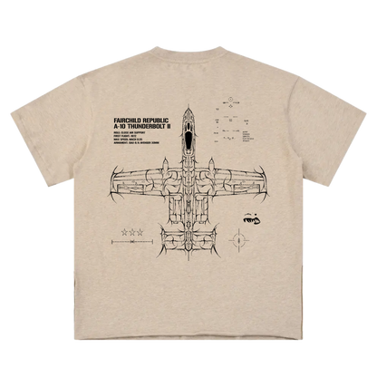Tan t-shirt with aviation-inspired line art of A-10 Thunderbolt II and technical details on back