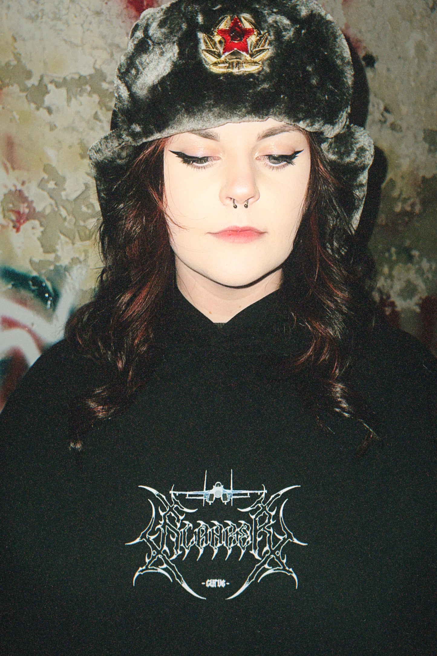 Woman in aviation streetwear hoodie and faux fur ushanka hat with red star badge