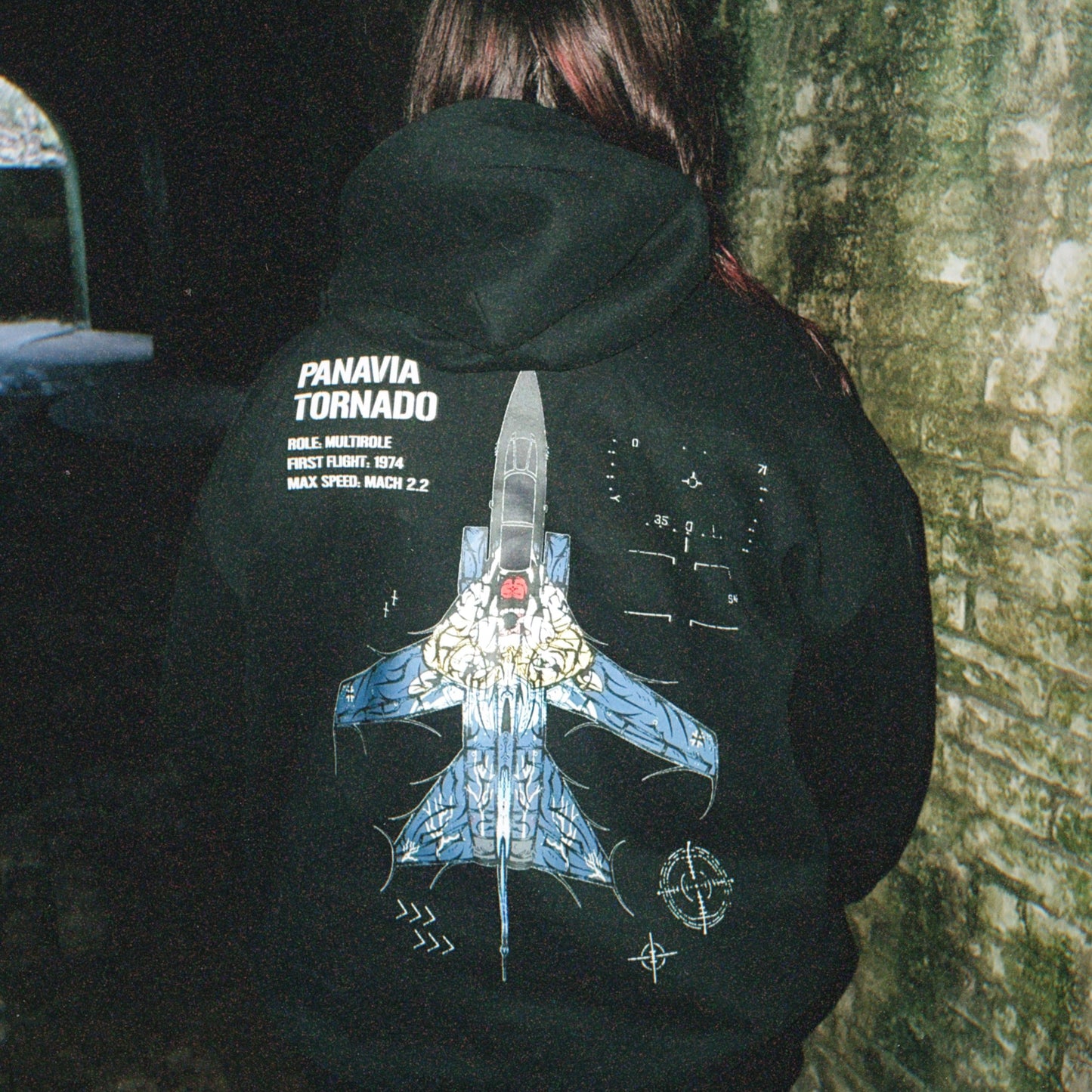 Person wearing black hoodie with Panavia Tornado jet graphic and tactical aviation details