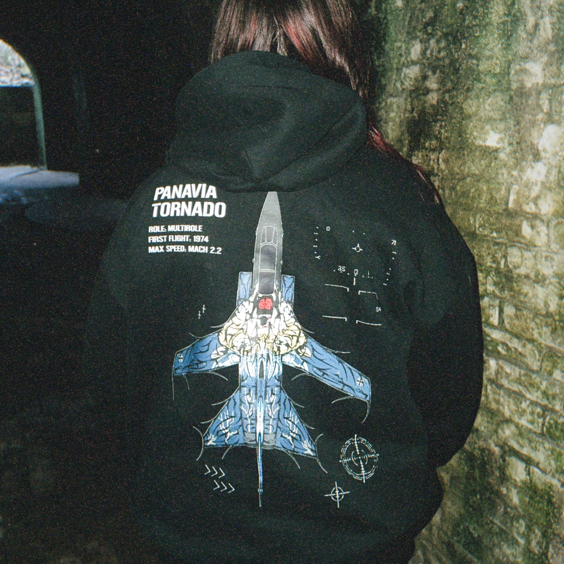 Person wearing black hoodie with Panavia Tornado jet graphic and tactical aviation details