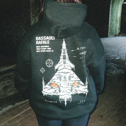 Person wearing black hoodie with Dassault Rafale jet and tiger graphic, tactical streetwear