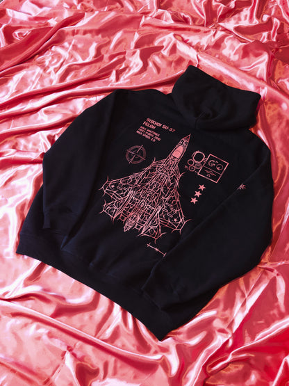 Black tactical streetwear sweatshirt with aviation line art and graphics, laid on pink satin.