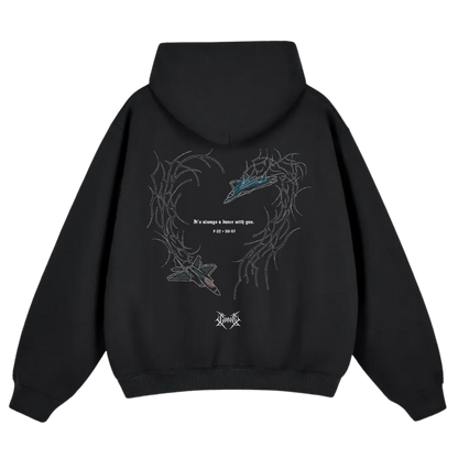 Black hoodie with aviation-inspired graphic of two fighter jets and swirling linework on the back.