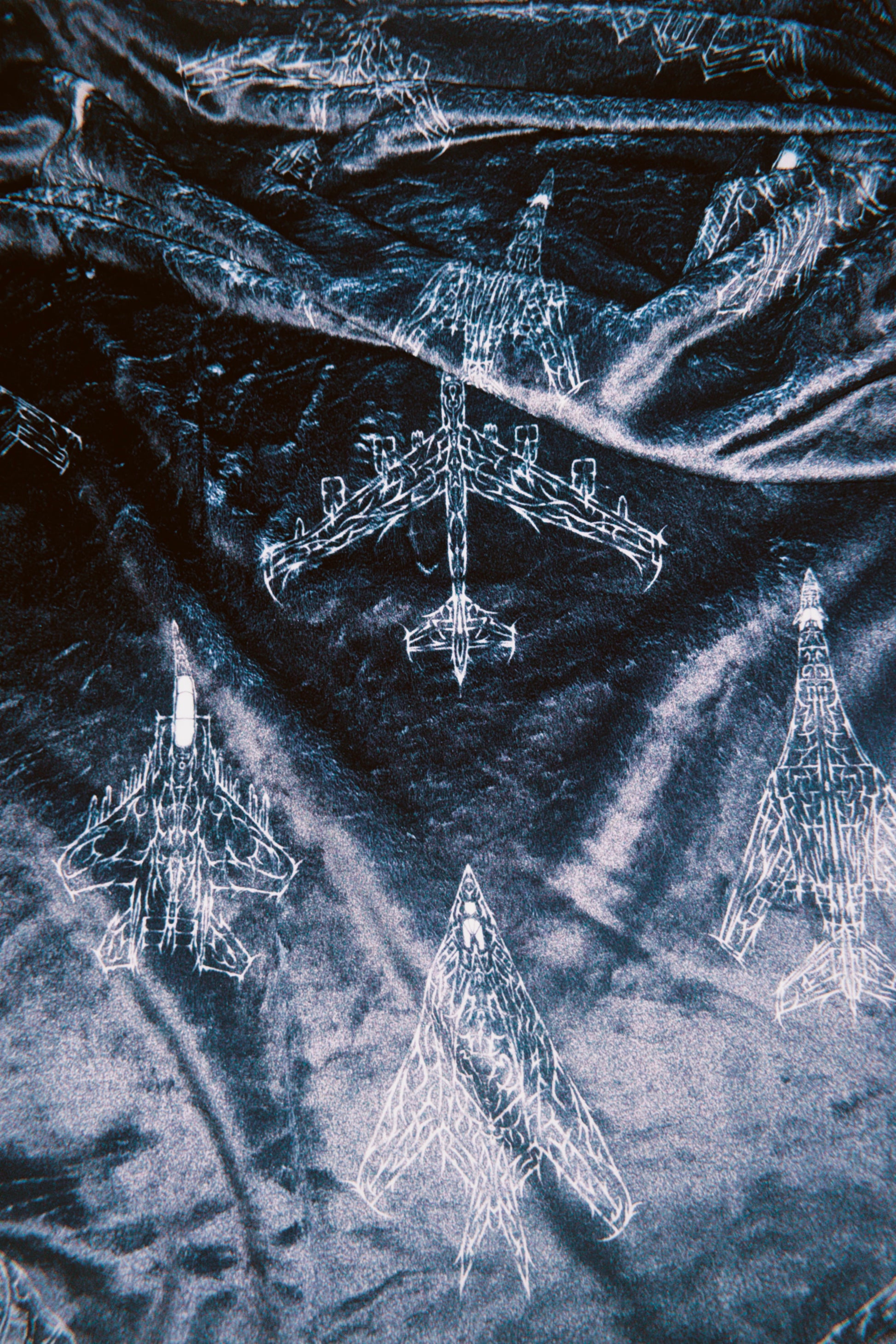 Black fabric with white aviation linework illustrations of fighter jets, tactical streetwear pattern