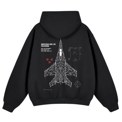 Black hoodie with white line art of MiG-29 fighter jet, technical specs, and red star accents.