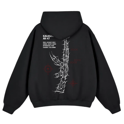 Black hoodie with white line art rifle graphic, red target icons, and technical text on the back.