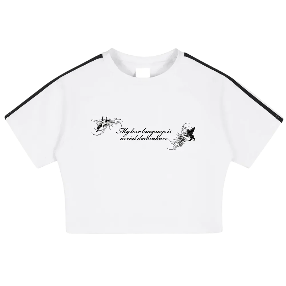 White cropped t-shirt with black shoulder stripes, jet illustrations, and 'My love language is aerial dominance' text.